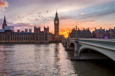 Bridge over river with buildings in background