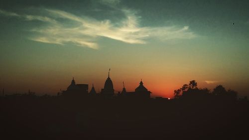 Silhouette of temple against sky at sunset