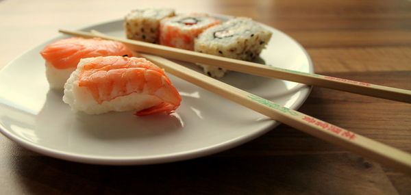 Sushi in plate on table at home