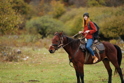 Man riding horse on field