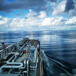 Scenic view of a vessel navigating over the sea against sky