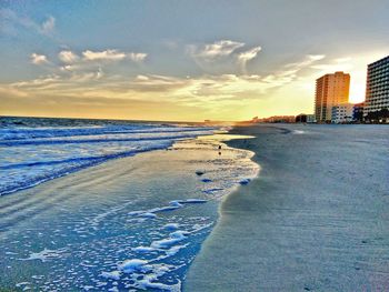 Scenic view of sea against sky in city