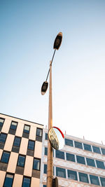 Low angle view of street light against building