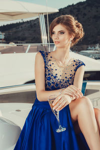 Beautiful young perfect girl in a dress and makeup, summer trip on a yacht with white sails on 