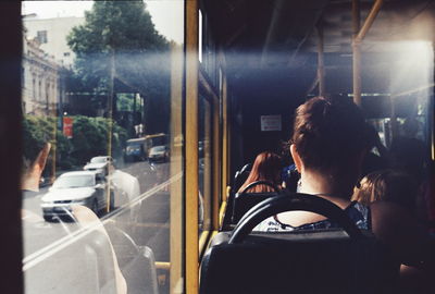 Rear view of people traveling in bus