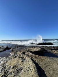 Scenic view of sea against clear blue sky