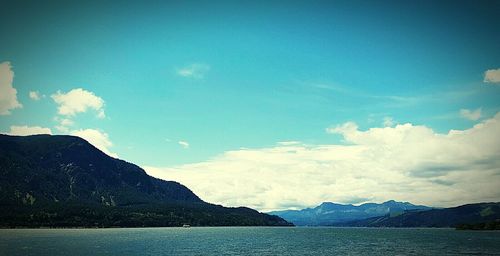 Scenic view of mountains against cloudy sky