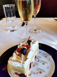 Close-up of drink and cake served on table