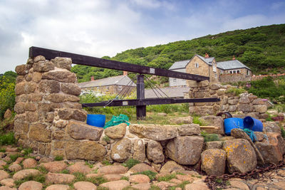 Built structure on rocks against sky