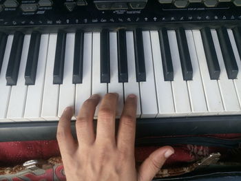 Cropped image of hands playing piano