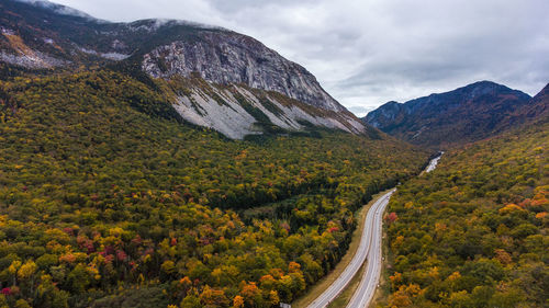 Scenic view of road amidst mountains against sky