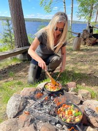 Woman preparing food on barbecue grill