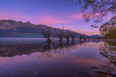 Scenic view of lake against sky during sunset