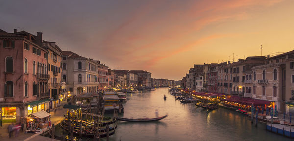 Boats moored at waterfront during sunset