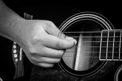 Close-up of man hand playing guitar