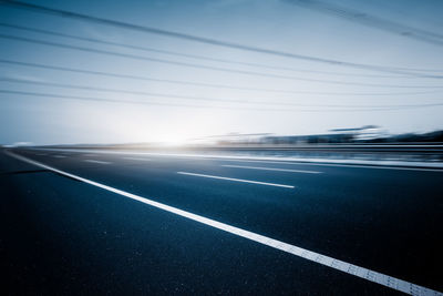 View of empty road against blue sky