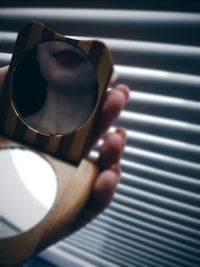 Cropped image of woman holding mirror 