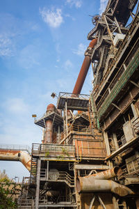 Low angle view of old factory against sky