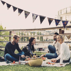 Young couple sitting on table outdoors