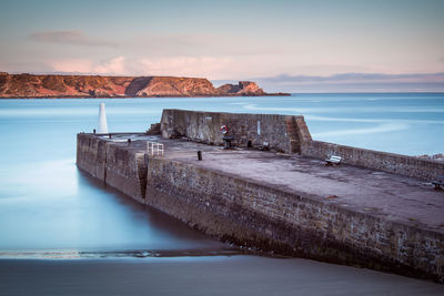Scenic view of sea against cloudy sky