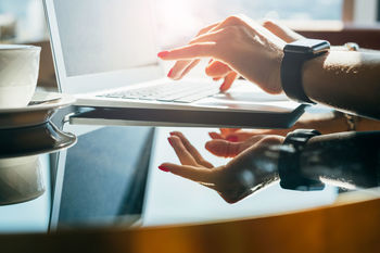 Close-up of businessman using laptop on table