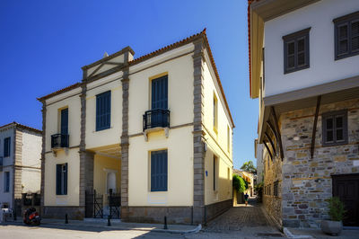 Low angle view of buildings against blue sky