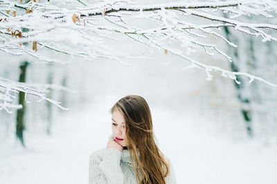 Young woman standing on snow