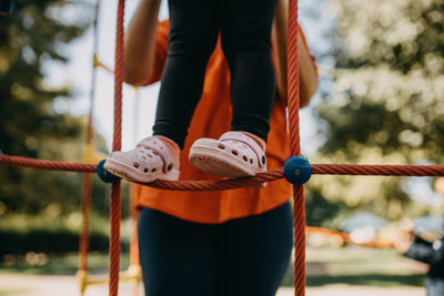 Low section of person standing on rope