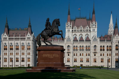 Statue in front of historical building