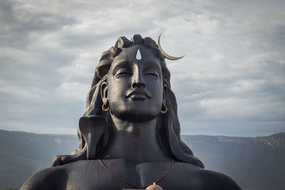 Low angle view of statue against cloudy sky