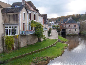 View of stream by buildings