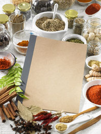 Various spices with book on table