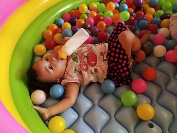 High angle view of baby boy lying in toys