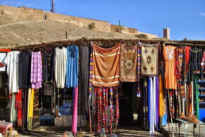 Clothes drying on display at market stall