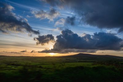 Scenic view of field against sky during sunset