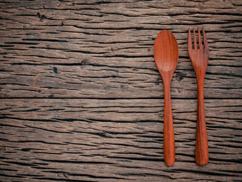 High angle view of wooden spoon and fork on table