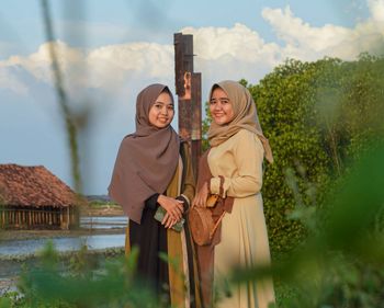 Portrait of smiling young moslem woman standing outdoors