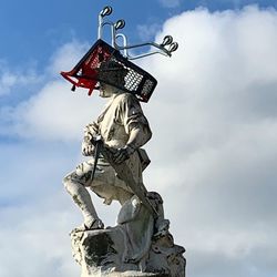 Low angle view of statue against sky