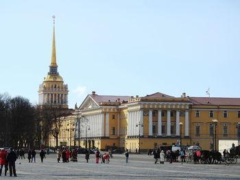 People at temple against clear sky