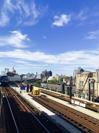 High angle view of railroad tracks in city against sky