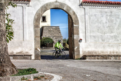 Bicycle by building in city