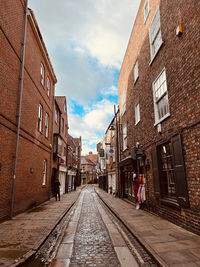 Street amidst buildings against sky