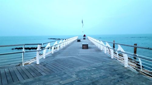 Pier over sea against clear sky