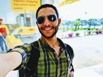 Portrait of smiling young man wearing sunglasses