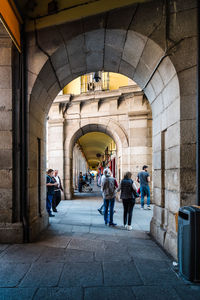 People walking in corridor of building