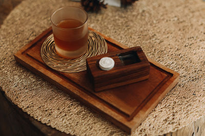 A glass of kambucha drink on a wooden stand. aesthetic natural details in the interior