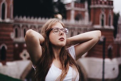 Close-up of young woman with closed eyes in city