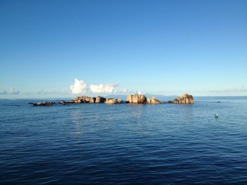 Scenic view of sea against clear blue sky