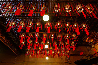 Low angle view of illuminated lanterns hanging on ceiling