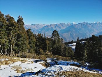 Scenic view of mountains against clear blue sky